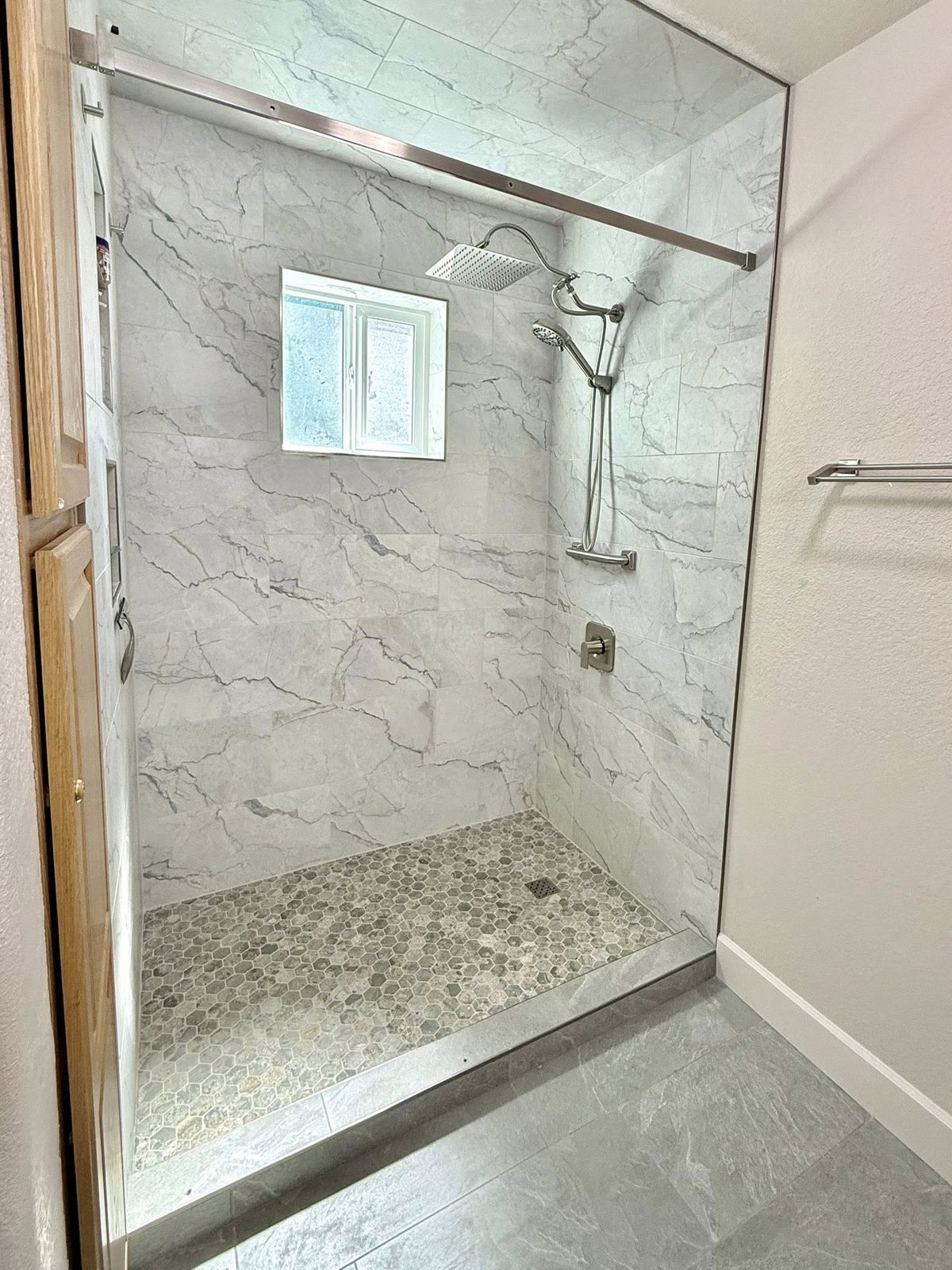 Marble-tiled walk-in shower