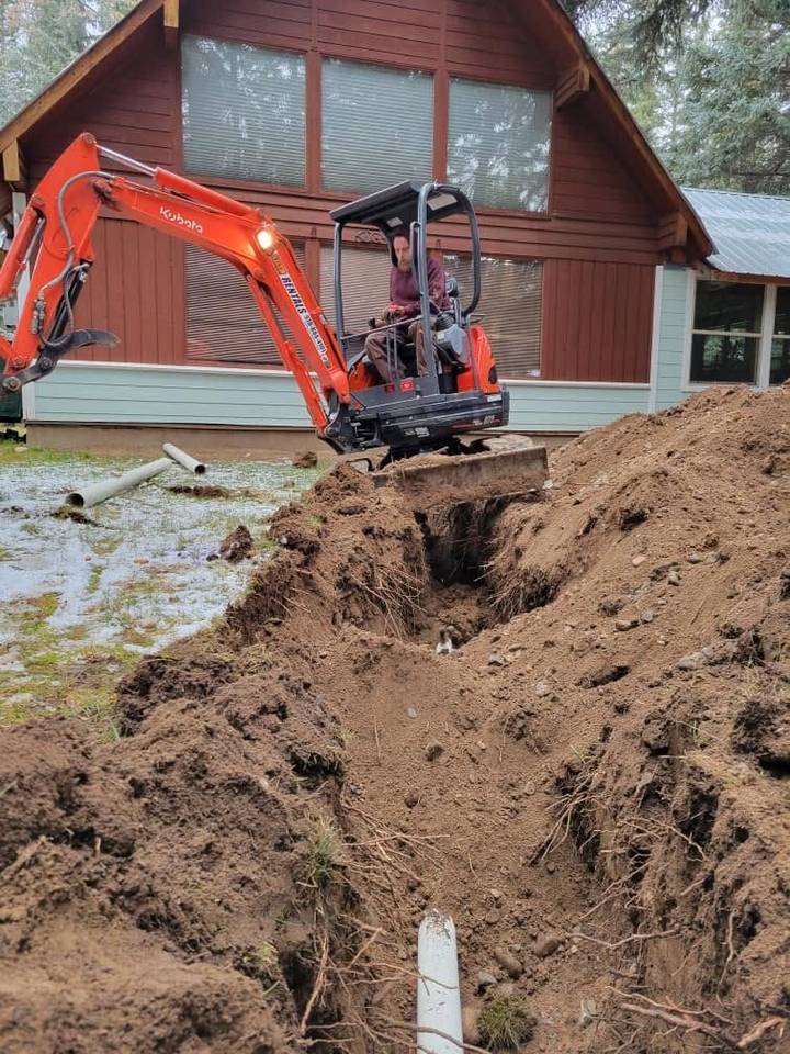 Aaron VanRiper running a mini-excavator on a site-work job