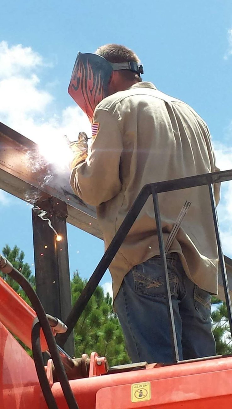 Aaron VanRiper of VR Solutions welding a steel beam on a jobsite