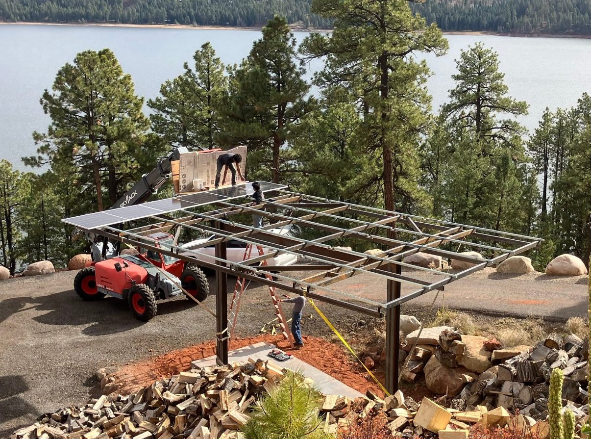 Steel solar-pergola frame being built on a lakeside lot above Vallecito Reservoir
