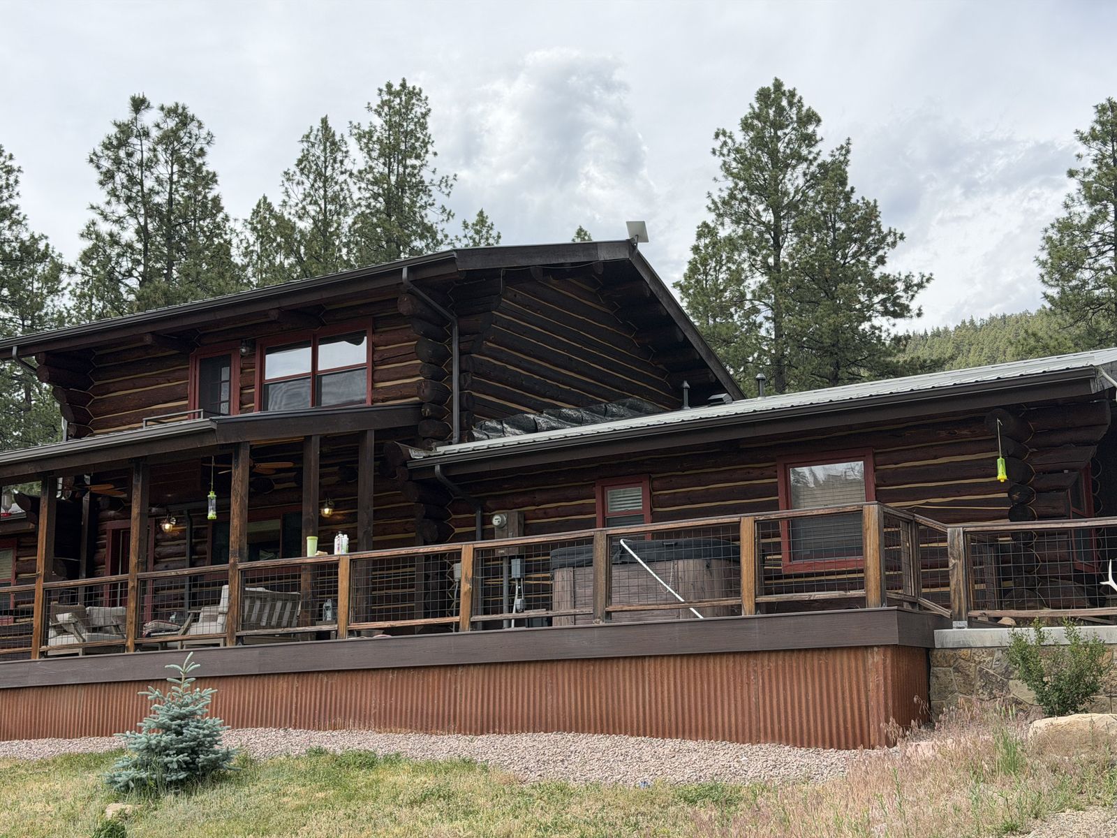A log home after a full exterior refinish in a deep walnut stain