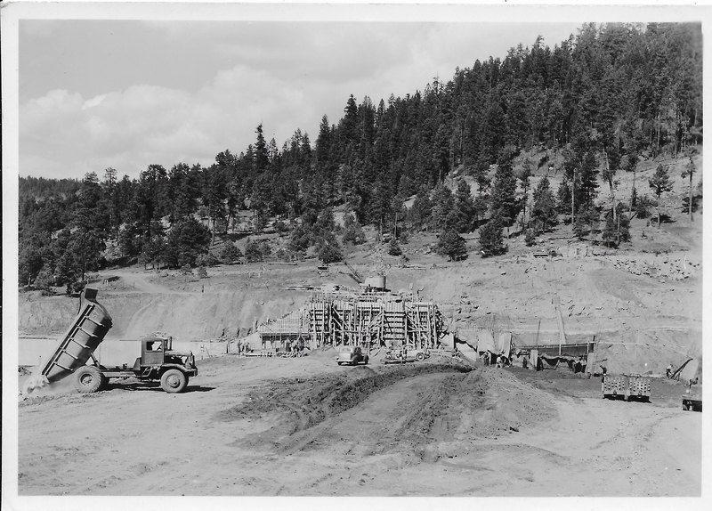 A crane and dump truck beginning to build up the Vallecito Dam wall