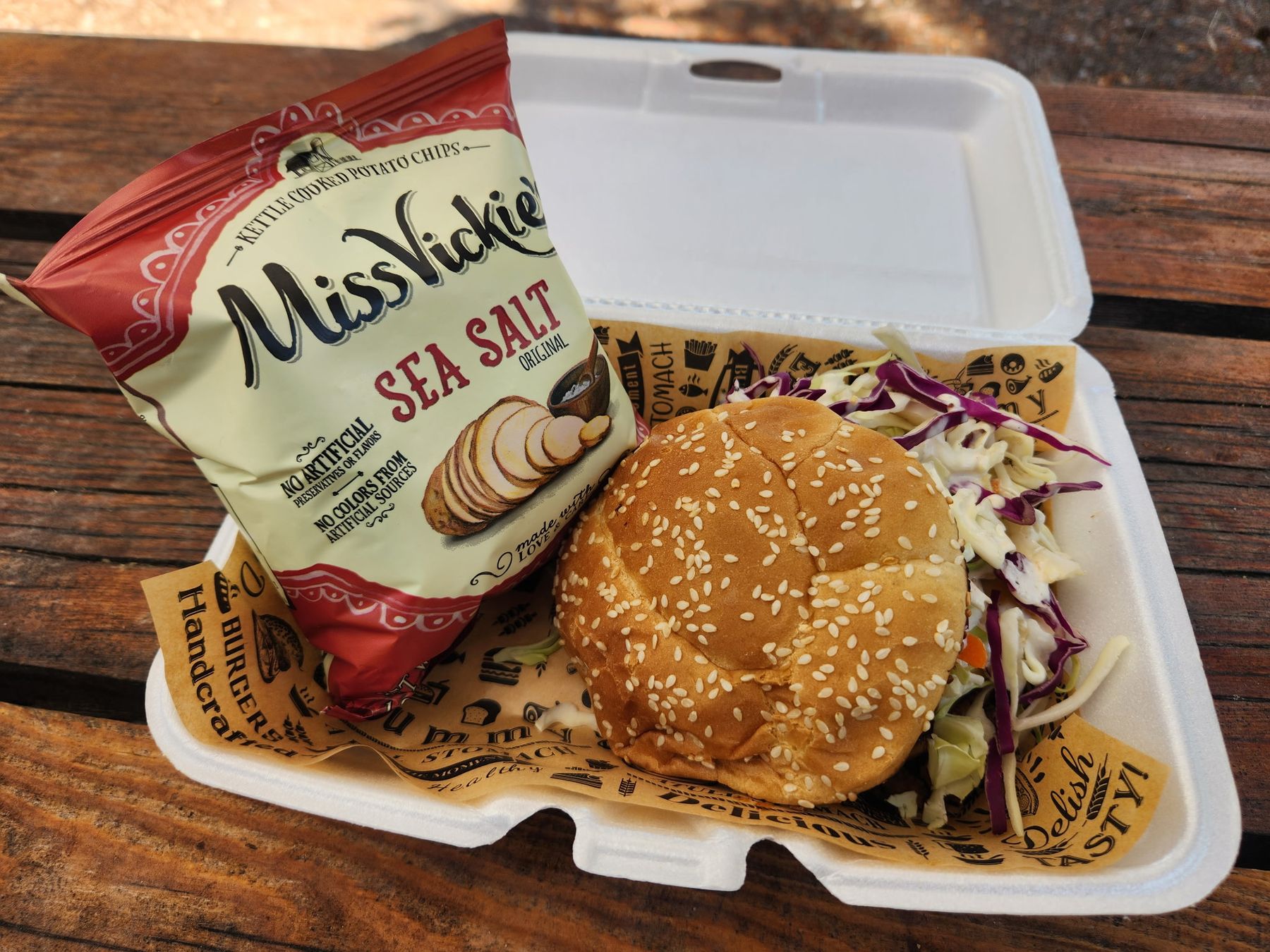 The Elk Sloppy Joe on a sesame bun with coleslaw on top and a side of Miss Vickie's kettle chips