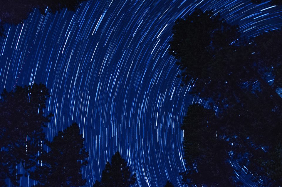 Star trails wheeling over Vallecito Lake at night